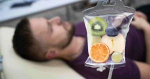 Patient receiving Intravenous (IV) Nutritional Therapy in Sandy, UT with a nutrient-rich infusion featuring fruits for hydration and wellness.