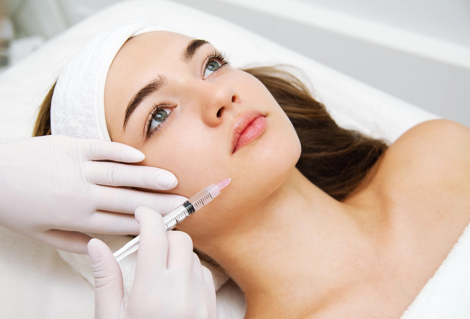 Woman receiving cosmetic injection representing peptide therapy treatment